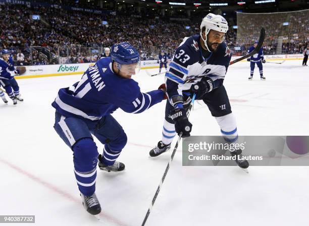 March 31 In the third period, Toronto Maple Leafs center Zach Hyman and Winnipeg Jets defenseman Dustin Byfuglien battle for the puck in the Jets...