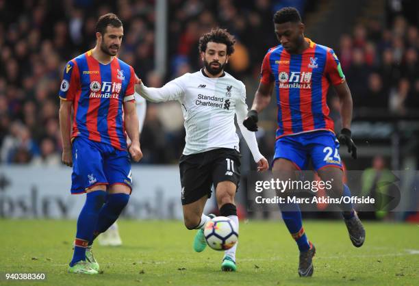 Mohamed Salah of Liverpool in action with Luka Milivojevic and Timothy Fosu-Mensah of Crystal Palace during the Premier League match between Crystal...