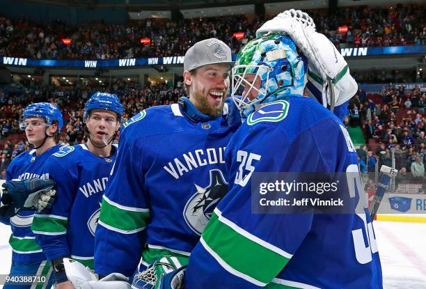 Jacob Markstrom of the Vancouver Canucks congratulates teammate Thatcher Demko after their NHL game against the Columbus Blue Jackets at Rogers Arena...