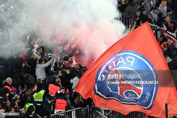 Paris Saint-Germain's supporters celebrate after victory in the French League Cup final football match between Monaco and Paris Saint-Germain at The...