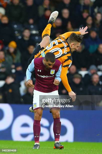 Angus MacDonald of Hull City clashes with Lewis Grabban of Aston Villa during the Sky Bet Championship match between Hull City and Aston Villa at...
