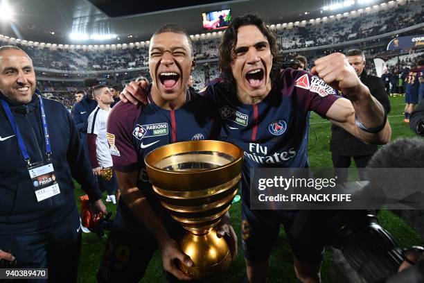 Paris Saint-Germain's French forward Kylian Mbappé and teammate Uruguayan forward Edinson Cavani celebrate after victory in the French League Cup...