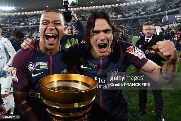 Paris Saint-Germain's French forward Kylian Mbappé and teammate Uruguayan forward Edinson Cavani celebrate after victory in the French League Cup...
