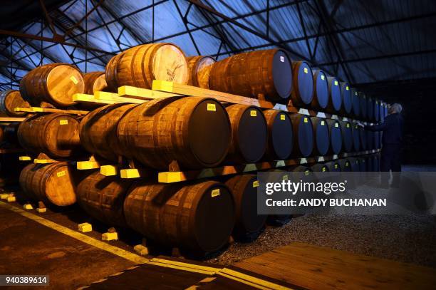 Emplyee Nigel Baker works in one of the distillery warehouses where the oak barrels of whisky can be stored for up to 25 years before bottling, at...