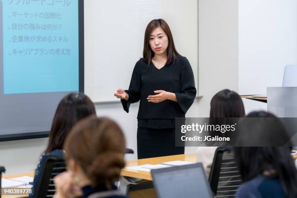 female businesswoman giving a presentation - japan training session stock pictures, royalty-free photos & images