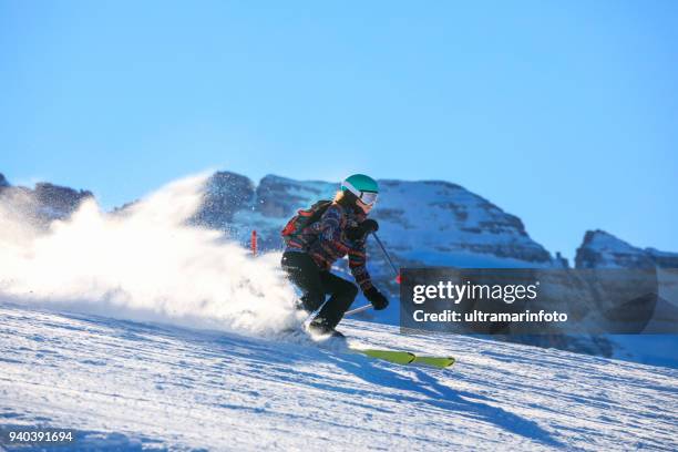 woman snow skier skiing at sunny ski resort amateur winter sports. high mountain snowy landscape.  italian alps mountain of the dolomites madonna di campiglio, italy. - extreme skiing stock pictures, royalty-free photos & images