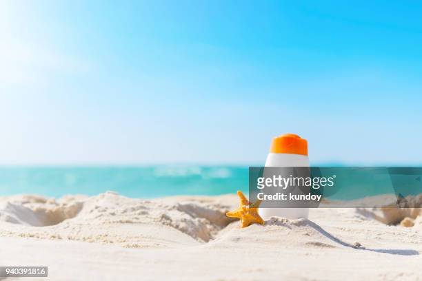 summer time on the beach with sunblock. - sunscreen ストックフォトと画像