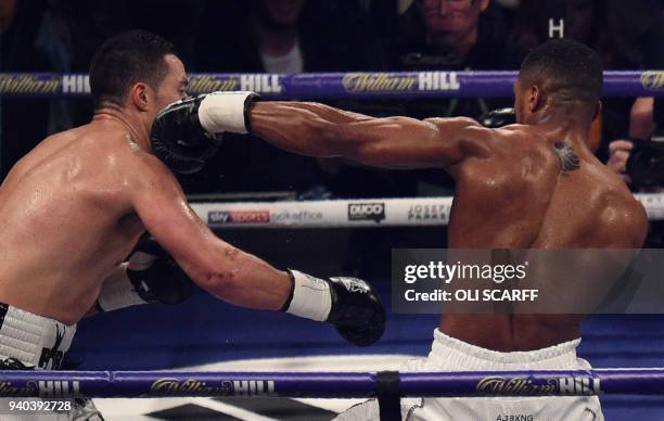 Anthony Joshua of Great Britain connects with a straight left against Joseph Parker of New Zealand during their heavyweight unification bout at...