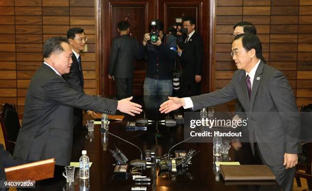 In this handout photo, South Korean Unification Minister Cho Myoung-Gyon shakes hands with North Korean delegation head Ri Son-Gwon before their...