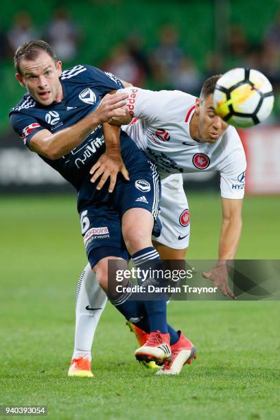 Christopher Ikonomidis of the Wanderers and Leigh Broxham of the Victory compete for the ball during the round 25 A-League match between the...