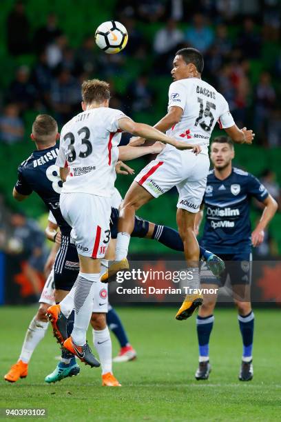 Michael Thwaite and Kearyn Baccus of the Wanderers jump to head the ball during the round 25 A-League match between the Melbourne Victory and the...