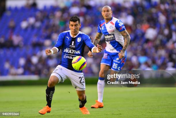 Edgar Benitez of Queretaro and Jorge Enriquez of Puebla fight for the ball during the 13th round match between Queretaro and Puebla as part of the...