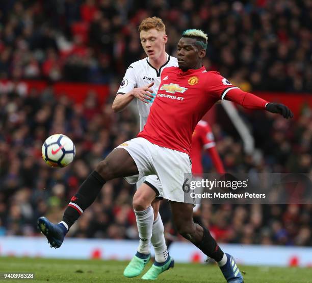 Paul Pogba of Manchester United in action with Sam Clucas of Swansea City during the Premier League match between Manchester United and Swansea City...