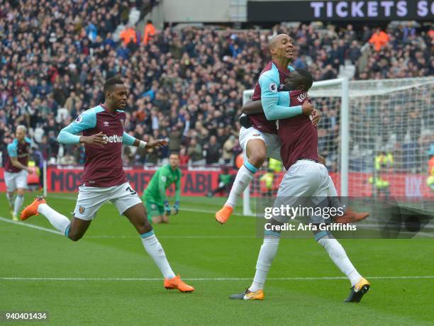 Joao Mario of West Ham United celebrates his goal with Cheikhou Kouyate and Edimilson Fernandes during the Premier League match between West Ham...