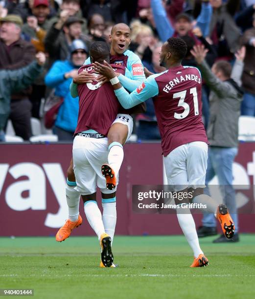 Joao Mario of West Ham United celebrates scoring with Edimilson Fernandes and Cheikhou Kouyate during the Premier League match between West Ham...