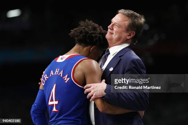 Devonte' Graham of the Kansas Jayhawks reacts with head coach Bill Self late in the second half against the Villanova Wildcats during the 2018 NCAA...