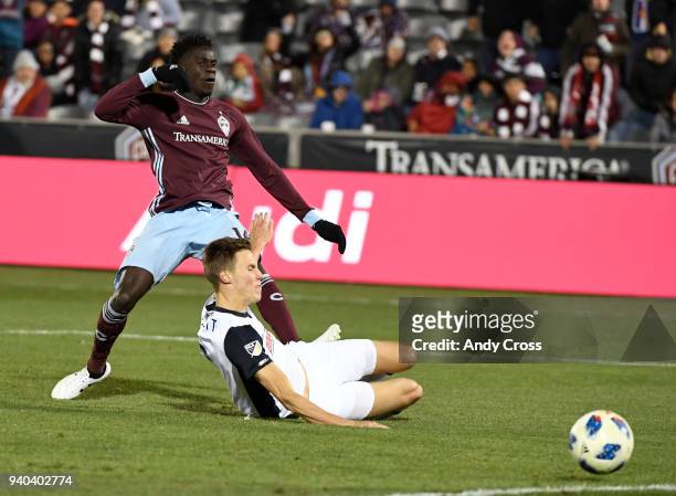 Dominique Badji, #14, shoots past Jack Elliott, #3, Philadelphia Union and scores in the second half at Dick's Sporting Goods Park March 31, 2018....
