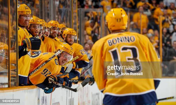 Ryan Johansen and Scott Hartnell wait to congratulate Nick Bonino of the Nashville Predators on his goal against the Buffalo Sabres during an NHL...