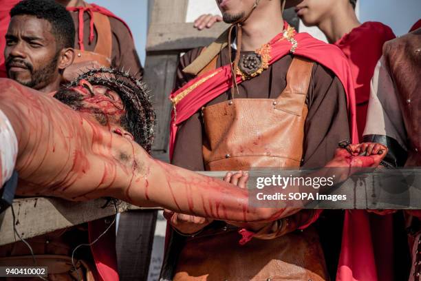 Actor of Jesus Christ seen on the cross. Community of El Morro neighborhood in Petare carry out via crucis de Cristo. Each year in Holy Week they...