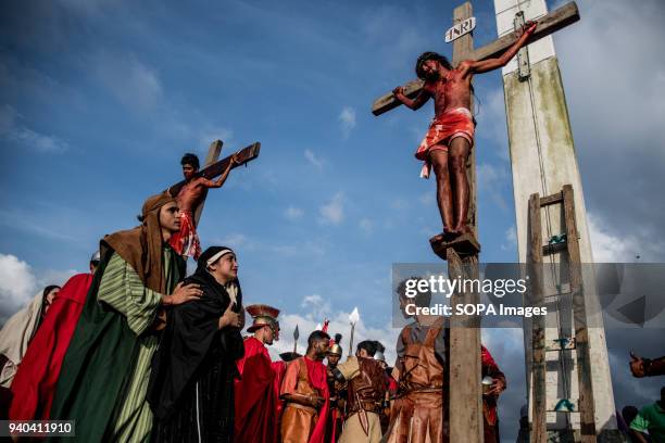 Actors seen on the cross. Community of El Morro neighborhood in Petare carry out via crucis de Cristo. Each year in Holy Week they perform the...