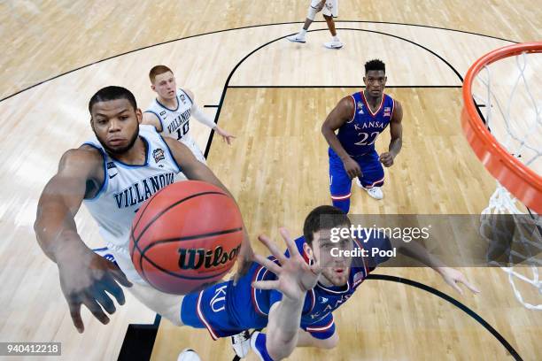 Omari Spellman of the Villanova Wildcats defends Sviatoslav Mykhailiuk of the Kansas Jayhawks in the second half during the 2018 NCAA Men's Final...