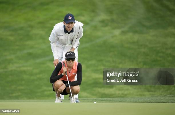 Pernilla Lindberg of Sweden and her caddie line up a putt on the 16th hole during the third round of the ANA Inspiration at Mission Hills Country...
