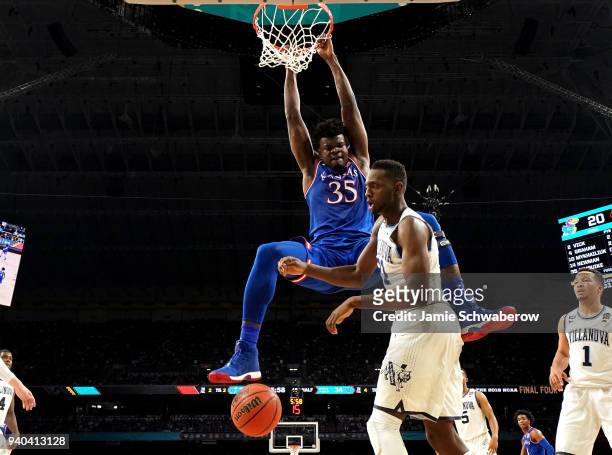 Udoka Azubuike of the Kansas Jayhawks dunks the ball against Dhamir Cosby-Roundtree of the Villanova Wildcats during the first half in the 2018 NCAA...