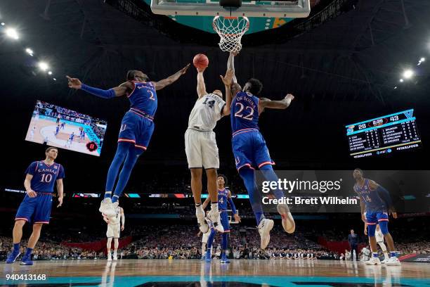 Omari Spellman of the Villanova Wildcats shoots the ball against Lagerald Vick and Silvio De Sousa of the Kansas Jayhawks during the first half in...