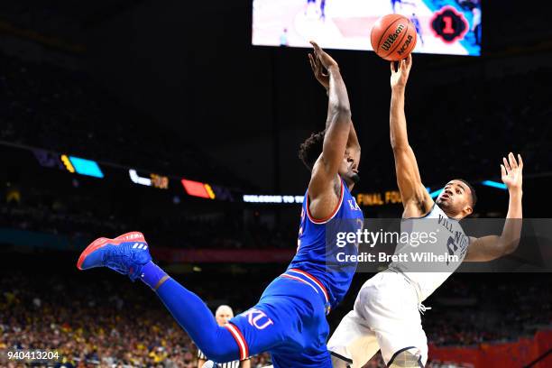 Phil Booth of the Villanova Wildcats shoots against Udoka Azubuike of the Kansas Jayhawks during the first half in the 2018 NCAA Photos via Getty...