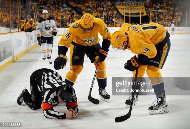 Subban and Mattias Ekholm of the Nashville Predators check on referee Ian Walsh after he was hit by the puck during an NHL game against the Buffalo...