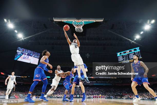 Phil Booth of the Villanova Wildcats attempts a lay up against the Kansas Jayhawks during the 2018 NCAA Photos via Getty Images Men's Final Four...