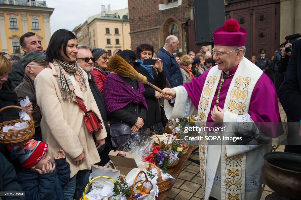 The Krakow archbishop, Marek Jdraszewski   blesses  people...