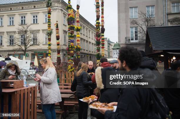 People eat traditional polish easter food in the Easter market at the main square in Krakow. Thousands of local gather in the main square of Krakow...