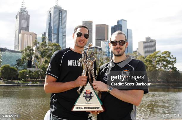 Melbourne United captain Chris Goulding and Josh Boone pose with the trophy after winning the NBL Grand Championship during a Melbourne United media...