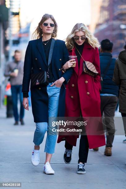 Constance Jablonski wearing an Yves Saint Laurent coat with Celine shoes and Off-White handbage and Elsa Hosk wearing a Le Ru Basics coat are seen in...