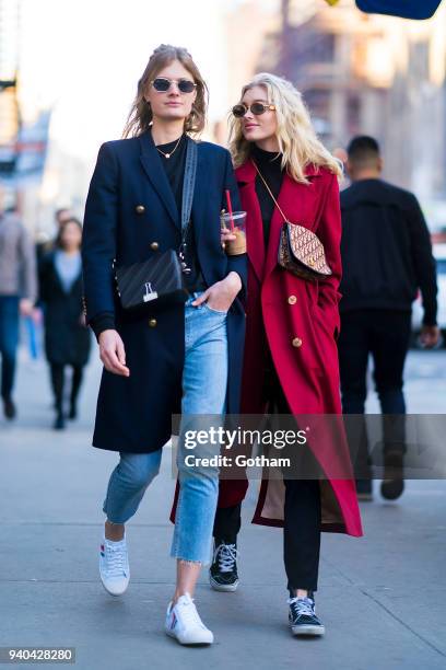 Constance Jablonski wearing an Yves Saint Laurent coat with Celine shoes and Off-White handbage and Elsa Hosk wearing a Le Ru Basics coat are seen in...