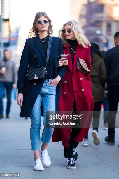 Constance Jablonski wearing an Yves Saint Laurent coat with Celine shoes and Off-White handbage and Elsa Hosk wearing a Le Ru Basics coat are seen in...