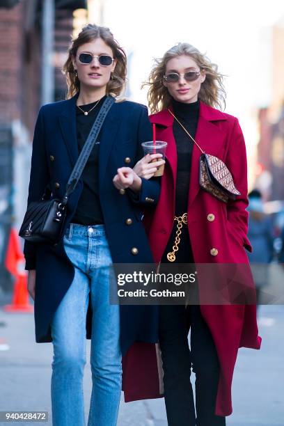 Constance Jablonski wearing an Yves Saint Laurent coat with Celine shoes and Off-White handbage and Elsa Hosk wearing a Le Ru Basics coat are seen in...