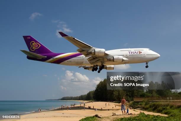 Thai Airways Boeing 747-400 about to complete a domestic flight from Bangkok and landing at Phuket over Mai Khao beach.