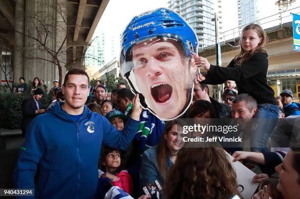 Bo Horvat of the Vancouver Canucks poses with a fan during a team autograph signing before their NHL game against the Columbus Blue Jackets at Rogers...