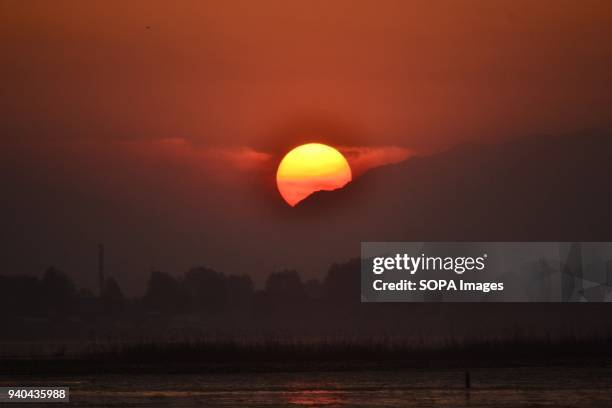 The Sun sets behind the mountains of Himalayan range in Srinagar, Indian administered Kashmir.