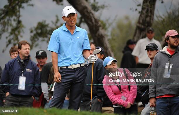 Anthony Kim of the US reacts after his 2nd hole tee shot at the Sherwood Country Club on day three of the Chevron World Challenge in Thousand Oaks,...
