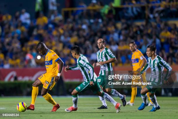 Enner Valencia of Tigres drives the ball while followed by players of Leon during the 13th round match between Tigres UANL and Leon as part of the...