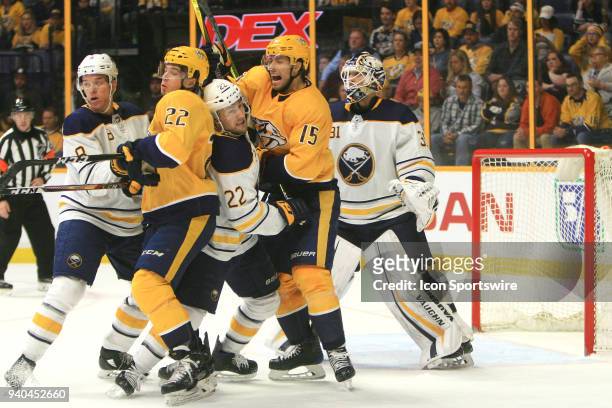 Buffalo Sabres defenseman Casey Nelson and center Johan Larsson battle for position with Nashville Predators left wing Kevin Fiala and right wing...
