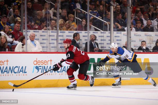 Oliver Ekman-Larsson of the Arizona Coyotes skates with the puck ahead of Kyle Brodziak of the St. Louis Blues during the second period of the NHL...