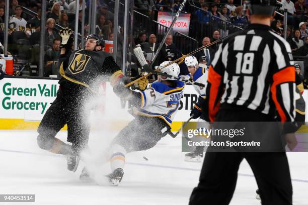 Vegas Golden Knights defenceman Colin Miller and St. Louis Blues center Oskar Sundqvist collide while going for the puck during the game between the...