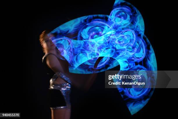 led poi. laser show performance, dancer in led suits with led lamp - laser show stock pictures, royalty-free photos & images