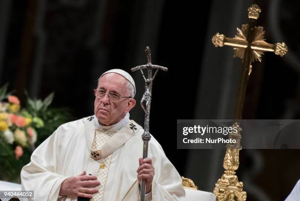 Pope Francis presides over a solemn Easter vigil ceremony in St. Peter's Basilica at the Vatican, Saturday, March 31, 2018.