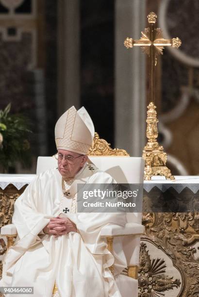 Pope Francis presides over a solemn Easter vigil ceremony in St. Peter's Basilica at the Vatican, Saturday, March 31, 2018.