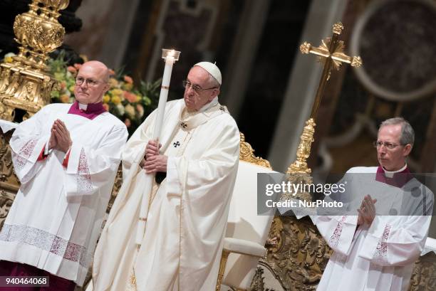 Pope Francis presides over a solemn Easter vigil ceremony in St. Peter's Basilica at the Vatican, Saturday, March 31, 2018.